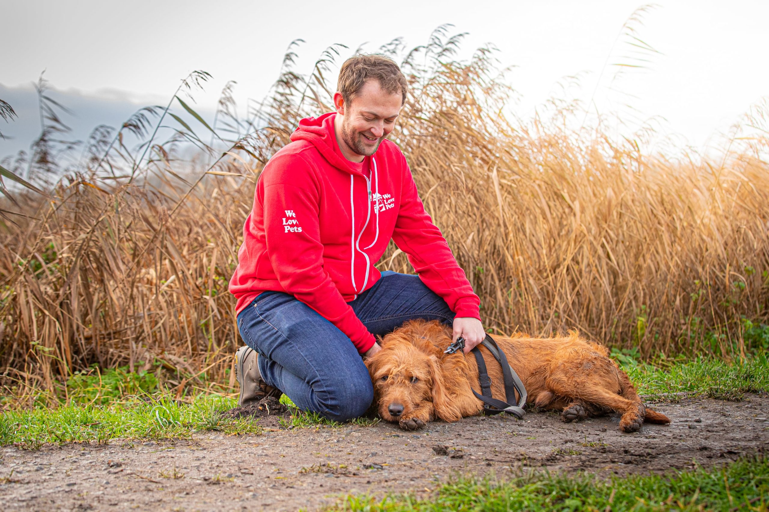 Jon from We Love Pets Newcastle sitting with dog