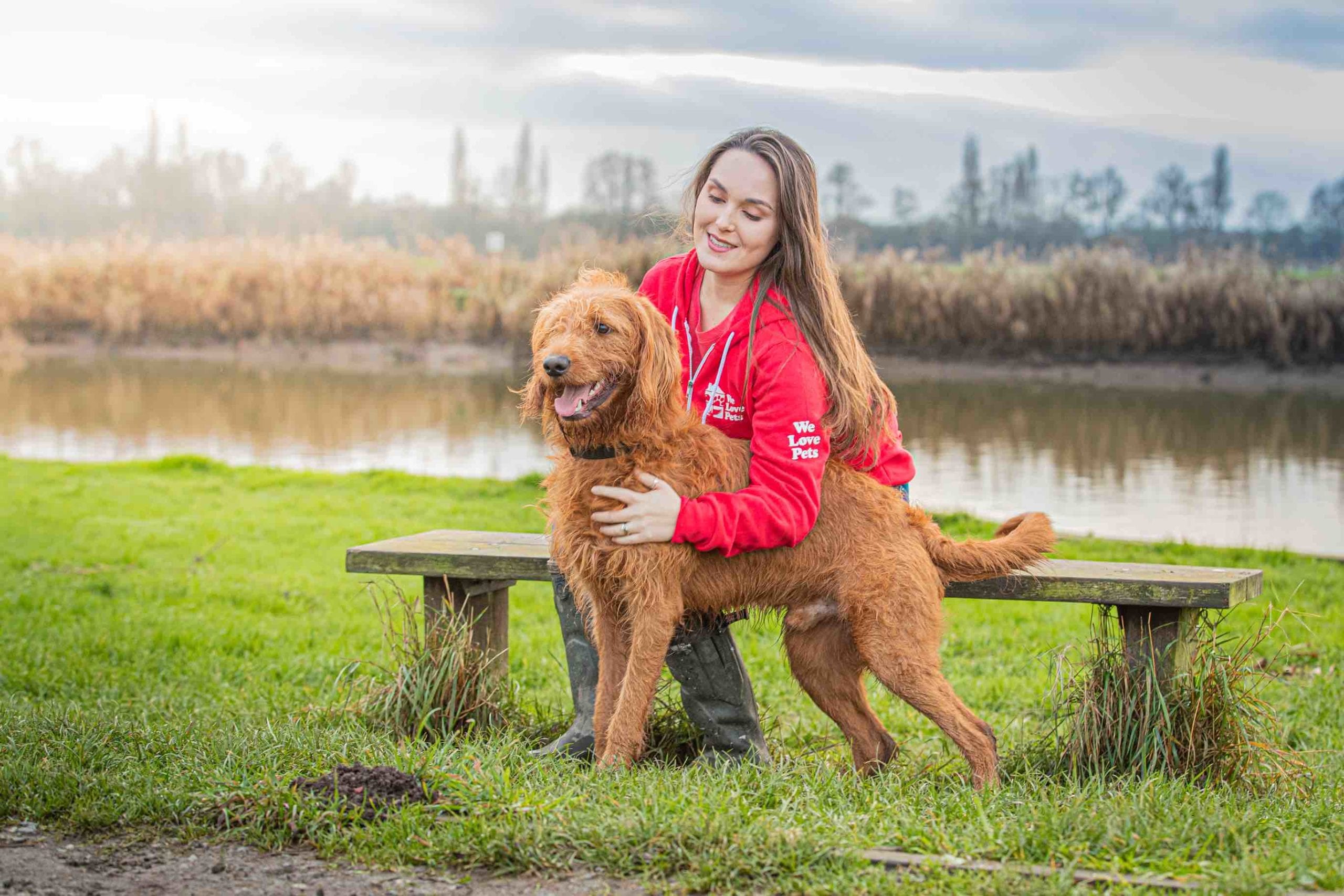 Lucy from We Love Pets Kidderminster hugging a dog