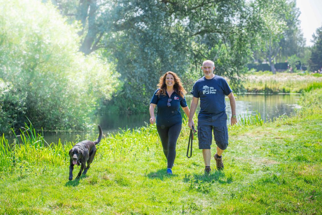 Man and Woman from We Love Pets Colchester walking dog off the lead