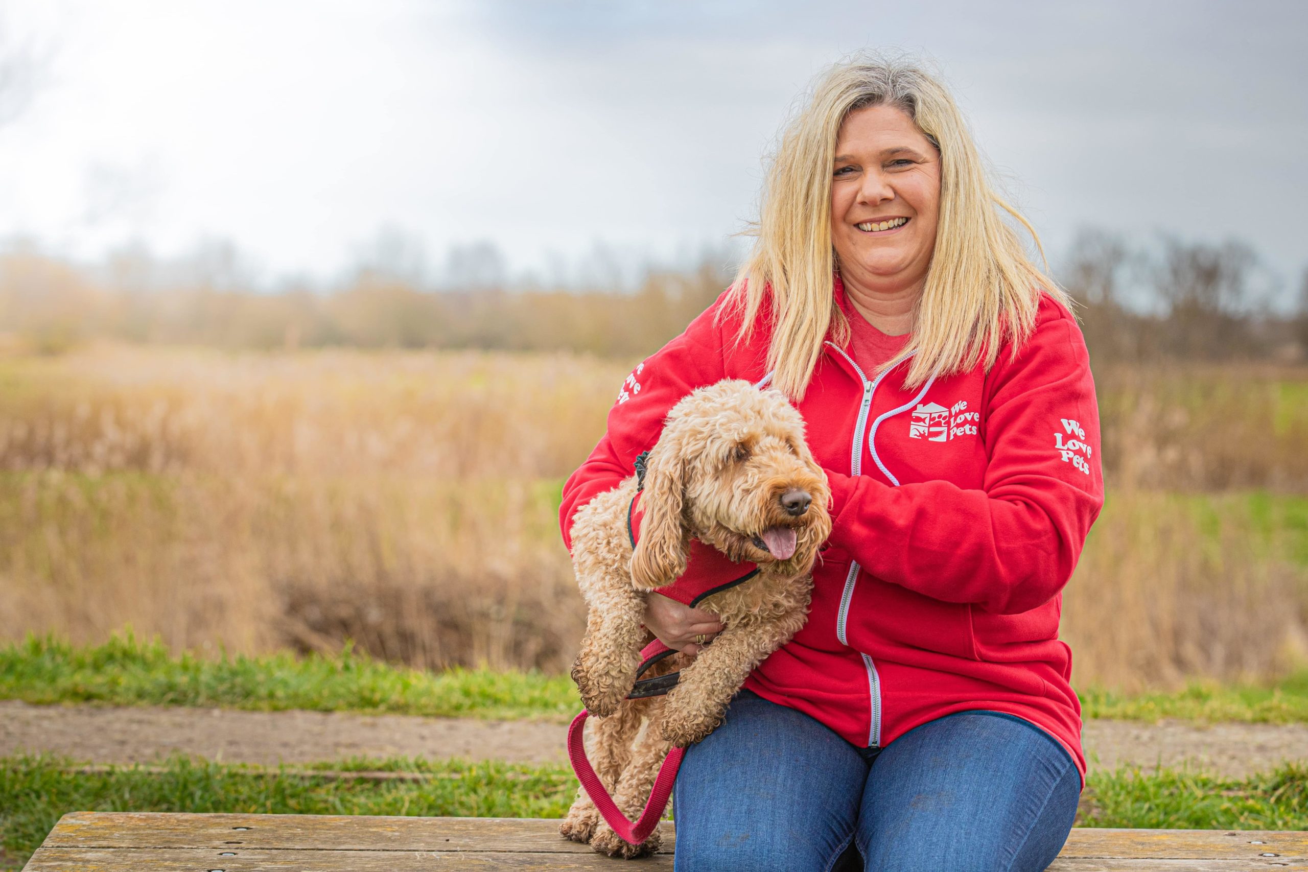 Charlotte from We Love Pets Ware sitting with a dog