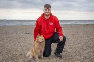 We Love Pets franchisee by the sea with a dog