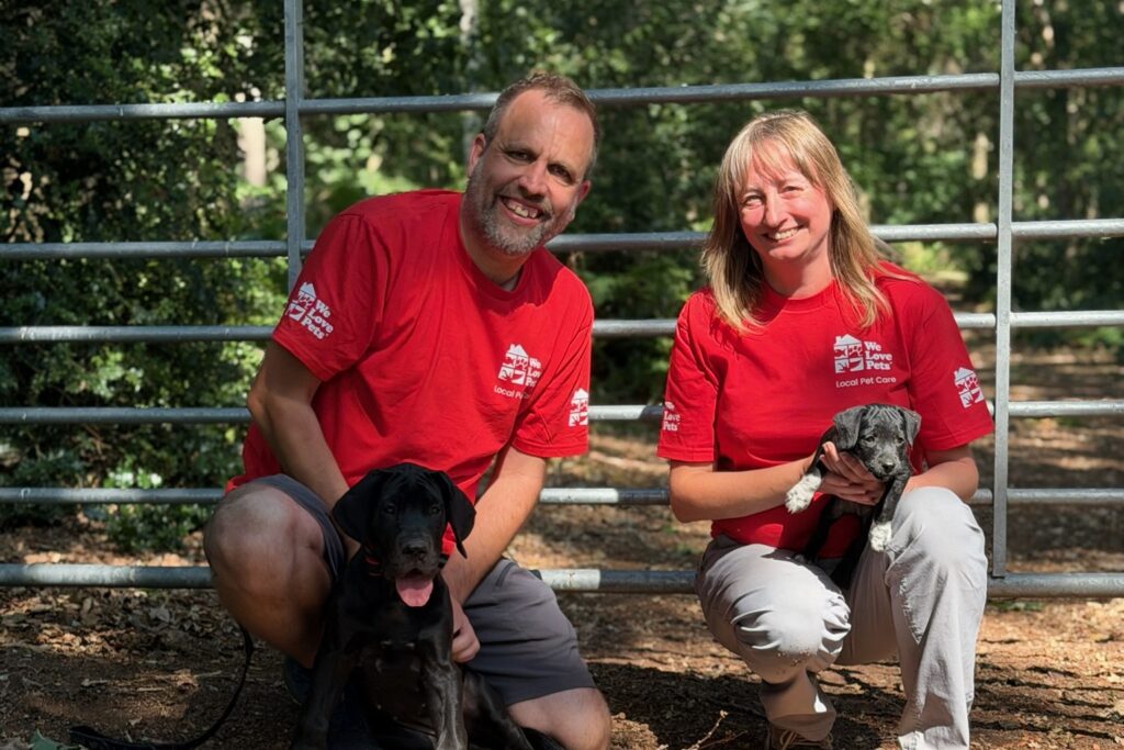 We Love Pets franchisees with two puppies