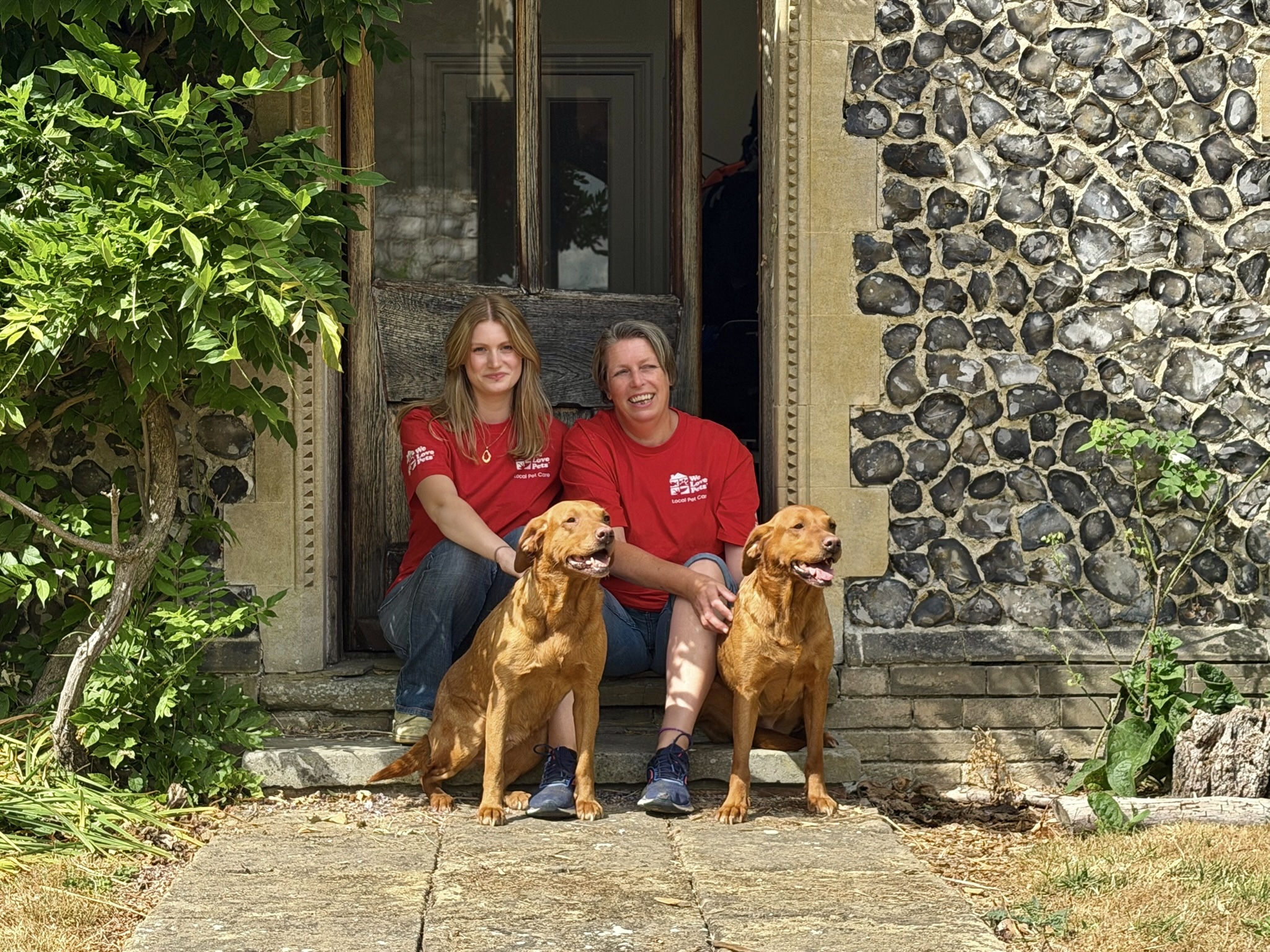 We Love Pets franchisee smiling with two dogs