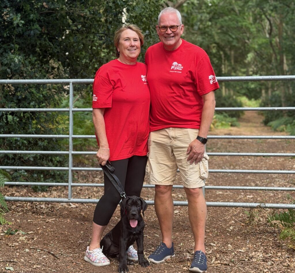 We Love Pets franchisee standing with a puppy