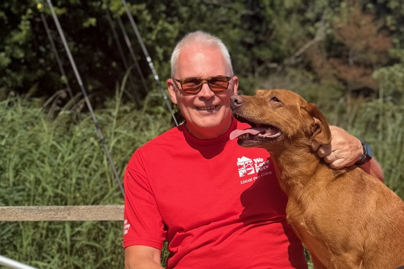 We Love Pets franchisee with a dog